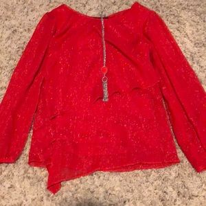 Shiny, red blouse with necklace